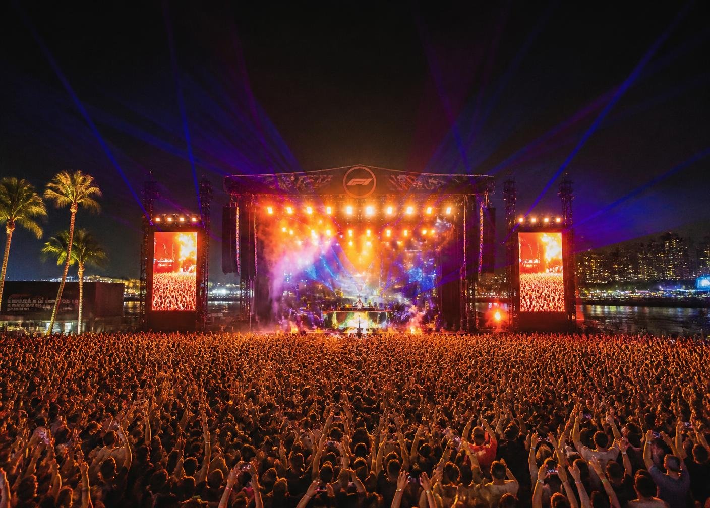 After-race concert stage lit with lasers in front of a large crowd